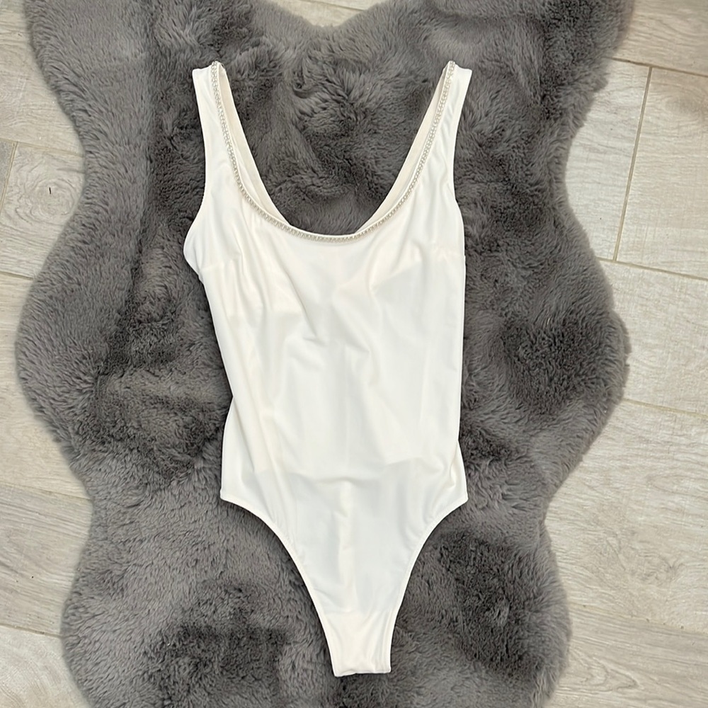 NWT Victoria’s Secret Cream bodysuit with Rhinestone trim. Size S. Buttery soft.